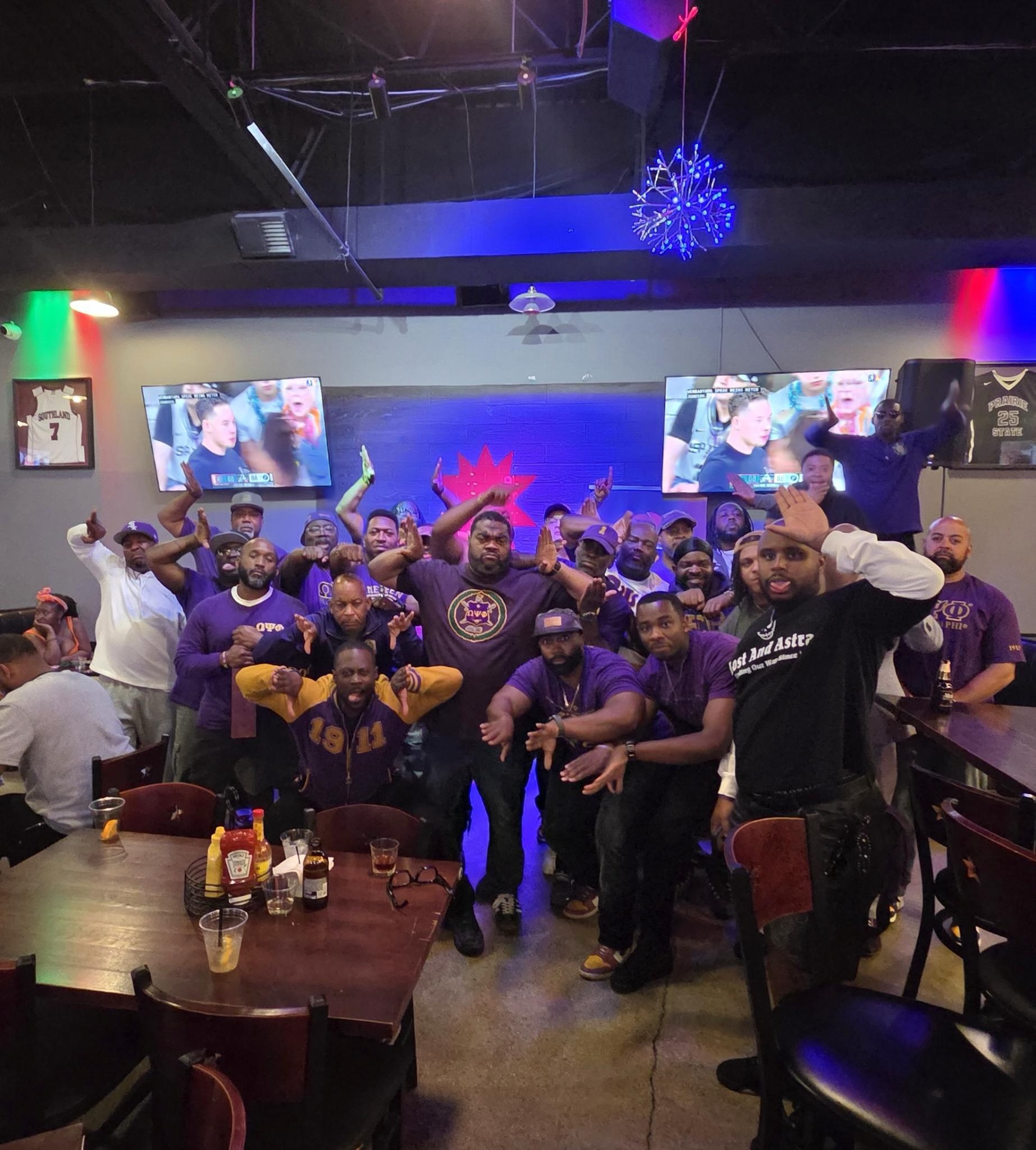 The brothers of Chi Lambda Lambda and their guests celebrate at Coleman–Love 2026, throwing up the Omega hooks at Redstar Kitchen | Bar.
